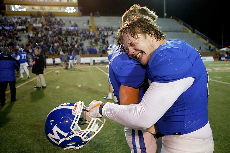 McCallie's James Howard, right, hugs teammate Chase Looper after the Blue Tornado won the TSSAA Division II-AAA championship by beating Montgomery Bell Academy 28-7 in Thursday night's BlueCross Bowl at Tennessee Tech. / Staff photo by C.B. Schmelter