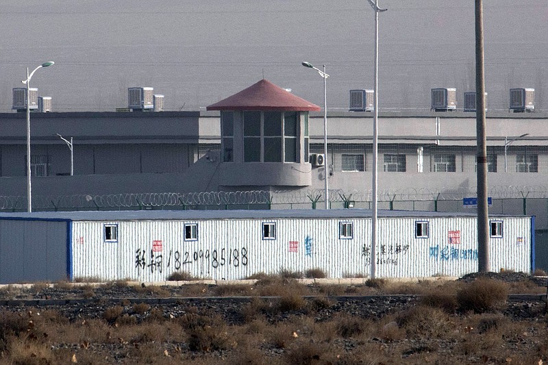 FILE - In this Monday, Dec. 3, 2018, file photo, a guard tower and barbed wire fences are seen around a facility in the Kunshan Industrial Park in Artux in western China's Xinjiang region. Congress is poised to hand President Donald Trump a chance to infuriate the Chinese government and attack its record on human rights as he is trying to deliver his long-sought trade deal (AP Photo/Ng Han Guan, File)