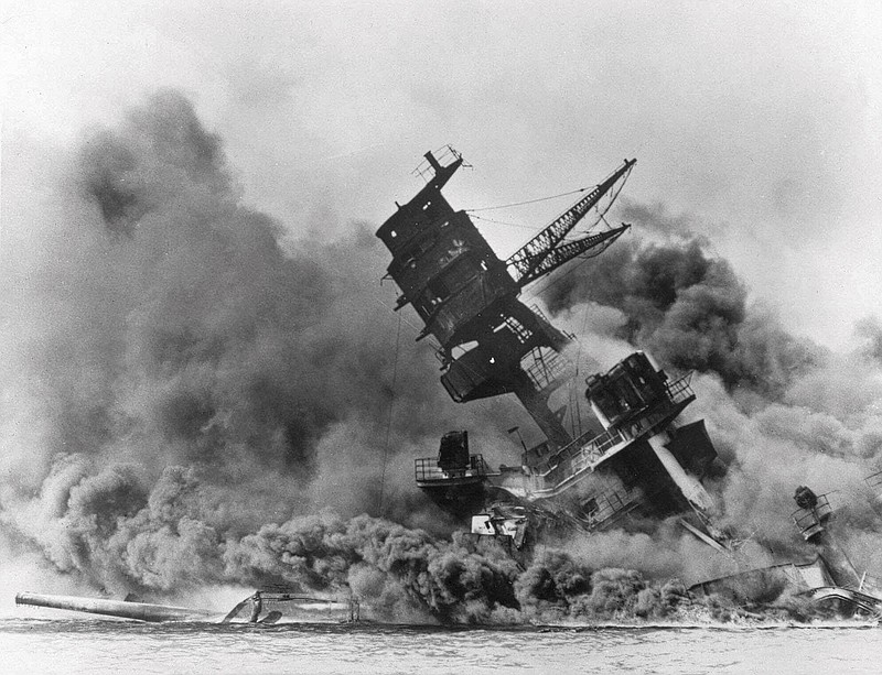 FILE - In this Dec. 7, 1941 file photo, smoke rises from the battleship USS Arizona as it sinks during the Japanese attack on Pearl Harbor, Hawaii. Divers will place the ashes of Lauren Bruner, a survivor from the USS Arizona in Pearl Harbor, in the wreckage of his ship during a ceremony this weekend.  Bruner died earlier in 2019 at the age of 98. (AP Photo, File)