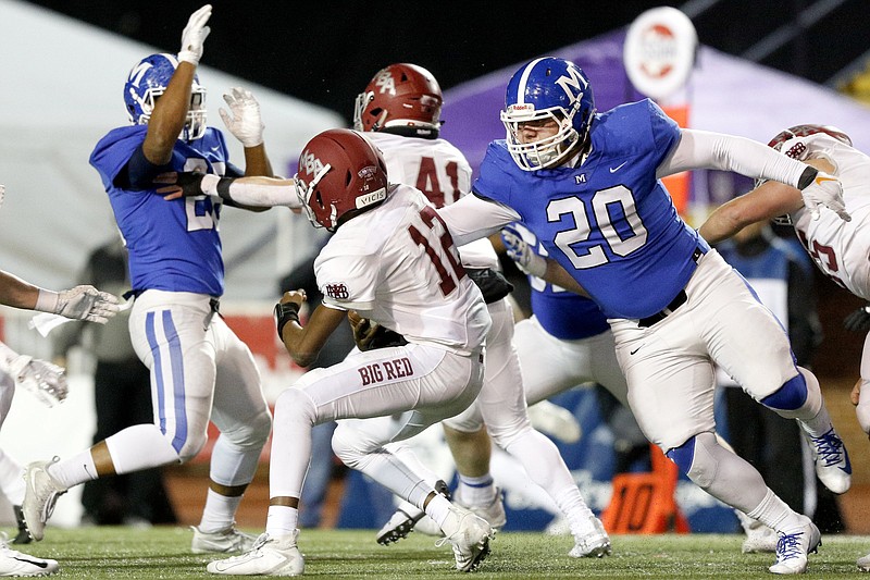 McCallie's James Howard (20) sacks MBA's Marcel Reed during the Division II-AAA BlueCross Bowl on Thursday night at Tennessee Tech's Tucker Stadium. Howard had two of the Blue Tornado's nine sacks that set a TSSAA record for a state title game and helped McCallie beat the Big Red 28-7. /Staff photo by C.B. Schmelter