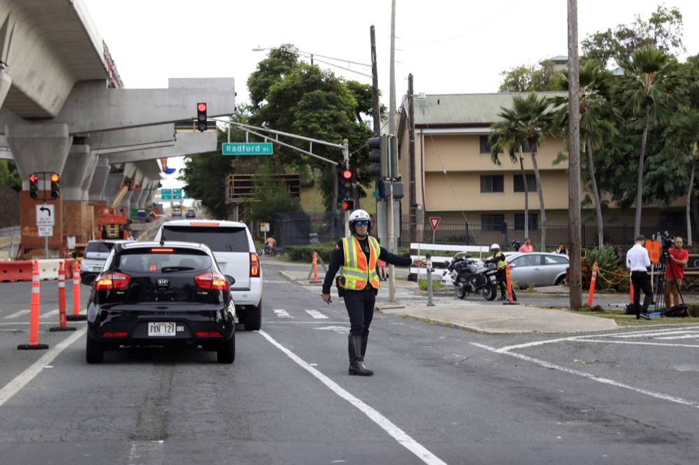 Police redirect traffic from the Makalapa Gate entrance to Joint Base Pearl Harbor-Hickam Wednesday, Dec. 4, 2019, in Honolulu. A shooting at Pearl Harbor naval shipyard in Hawaii left at least one person injured Wednesday, military and hospital officials said. Joint Base Pearl Harbor-Hickam spokesman Charles Anthony confirmed that there was an active shooting at Pearl Harbor naval shipyard. The military tweeted that it began around 2:30 p.m. Queen's Medical Center spokesperson Cedric Yamanaka said the hospital was treating one patient but didn't give e details on their condition. (AP Photo/Caleb Jones)