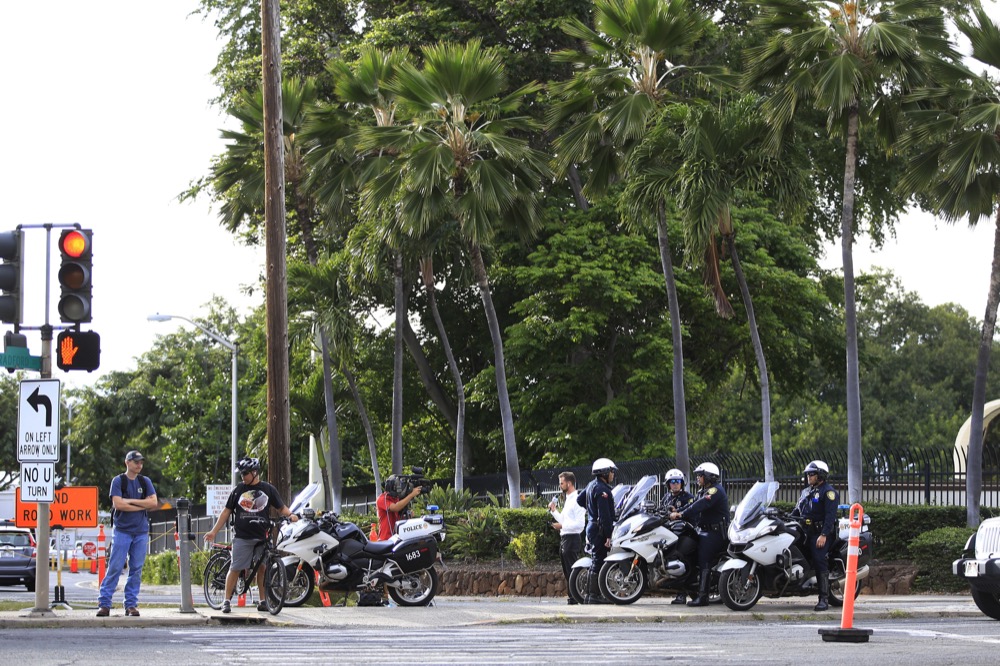 Police redirect traffic from the Makalapa Gate entrance to Joint Base Pearl Harbor-Hickam Wednesday, Dec. 4, 2019, in Honolulu. A shooting at Pearl Harbor naval shipyard in Hawaii left at least one person injured Wednesday, military and hospital officials said. Joint Base Pearl Harbor-Hickam spokesman Charles Anthony confirmed that there was an active shooting at Pearl Harbor naval shipyard. The military tweeted that it began around 2:30 p.m. Queen's Medical Center spokesperson Cedric Yamanaka said the hospital was treating one patient but didn't give e details on their condition. (AP Photo/Caleb Jones)