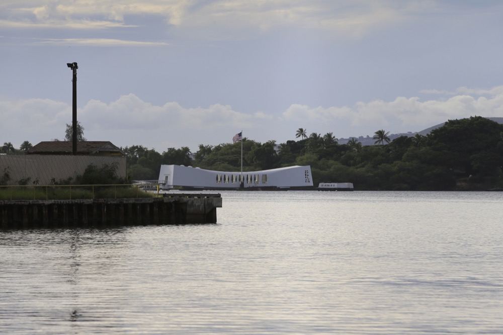 The USS Arizona Memorial can be seen from the Pearl Harbor National Memorial Wednesday, Dec. 4, 2019, in Honolulu. A shooting at Pearl Harbor naval shipyard in Hawaii left at least one person injured Wednesday, military and hospital officials said. Joint Base Pearl Harbor-Hickam spokesman Charles Anthony confirmed that there was an active shooting at Pearl Harbor naval shipyard. The military tweeted that it began around 2:30 p.m. Queen's Medical Center spokesperson Cedric Yamanaka said the hospital was treating one patient but didn't give e details on their condition. (AP Photo/Caleb Jones)