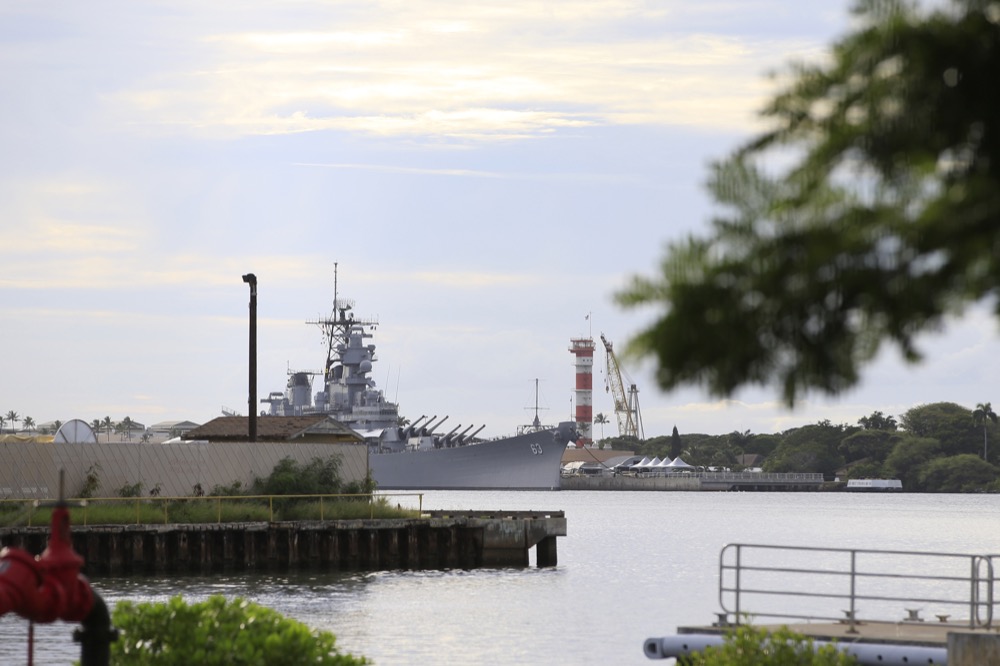 A US naval ship can been seen from Pearl Harbor National Memorial Wednesday, Dec. 4, 2019, in Honolulu. A shooting at Pearl Harbor naval shipyard in Hawaii left at least one person injured Wednesday, military and hospital officials said. Joint Base Pearl Harbor-Hickam spokesman Charles Anthony confirmed that there was an active shooting at Pearl Harbor naval shipyard. The military tweeted that it began around 2:30 p.m. Queen's Medical Center spokesperson Cedric Yamanaka said the hospital was treating one patient but didn't give e details on their condition. (AP Photo/Caleb Jones)
