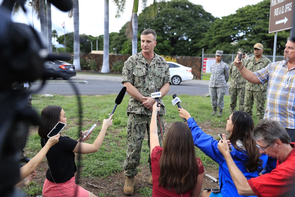 US Navy Rear Adm. Robb Chadwick speaks to the media at the main gate at Joint Base Pearl Harbor- Hickam Wednesday, Dec. 4, 2019, in Honolulu. A shooting at Pearl Harbor naval shipyard in Hawaii left at least one person injured Wednesday, military and hospital officials said. Joint Base Pearl Harbor-Hickam spokesman Charles Anthony confirmed that there was an active shooting at Pearl Harbor naval shipyard. The military tweeted that it began around 2:30 p.m. Queen's Medical Center spokesperson Cedric Yamanaka said the hospital was treating one patient but didn't give e details on their condition. (AP Photo/Marco Garcia)