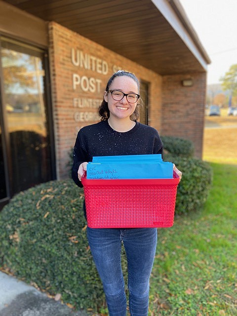 Contributed photo by Heather Culberson / Ridgeland High School student Daley Culberson shows off some of the fruits of her labor after organizing Chattanooga Valley Elementary School classes to participate in an Adopt-A-Veteran program, donating gift baskets to 25 servicemembers.