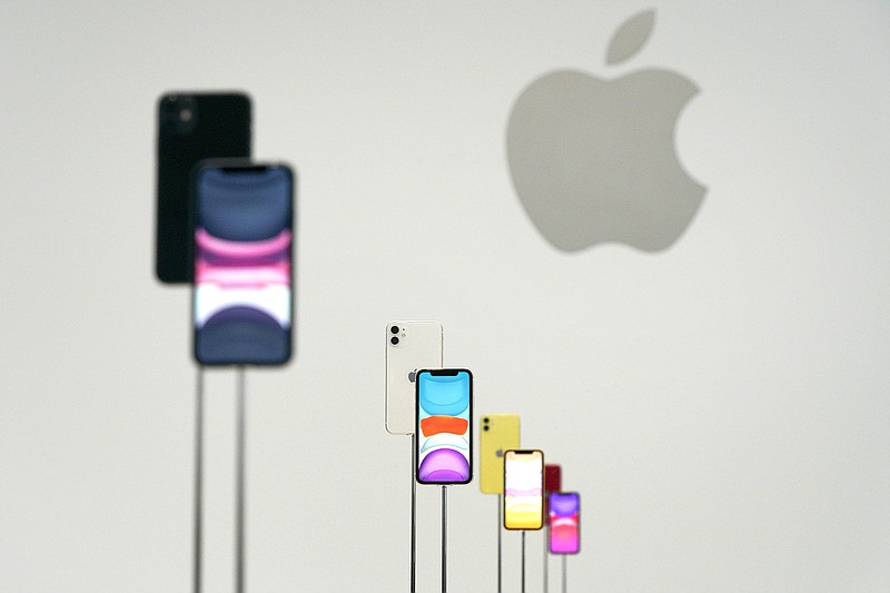 This Sept. 10, 2019, file photo shows the new Apple iPhone 11 on display during an event to announce new products in Cupertino, Calif. Apple is expanding its website on privacy with more explanations about its commitments. The new site Wednesday, Nov. 6, is part of Apple's ongoing push to distinguish itself from data-hungry, advertising-fueled rivals such as Google and Facebook. (AP Photo/Tony Avelar, File)