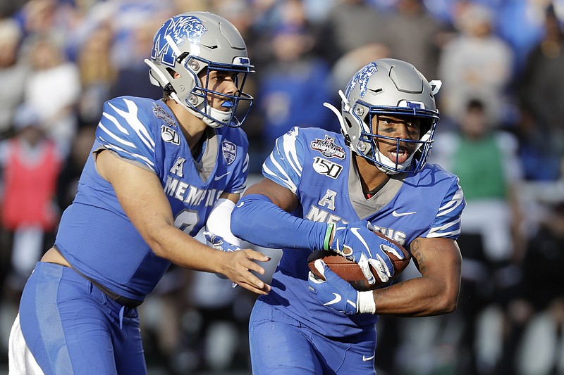 Memphis running back Kylan Watkins, right, takes a handoff from quarterback Brady White during the first half of the AAC title game against visiting Cincinnati on Saturday. / AP Photo by Mark Humphrey