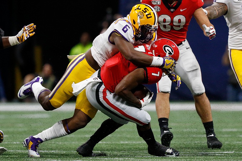 LSU linebacker Jacob Phillips tackles Georgia running back D'Andre Swift during the Southeastern Conference championship game Saturday at Mercedes-Benz Stadium in Atlanta. Swift, who was dealing with a shoulder injury, was lightly used in the game. / Staff photo by C.B. Schmelter