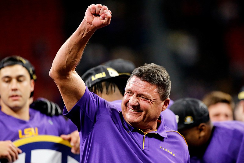 LSU football coach Ed Orgeron celebrates on stage Saturday night at Mercedes-Benz Stadiuum after the Tigers beat Georgia in the Southeastern Conference championship game in Atlanta. / Staff photo by C.B. Schmelter