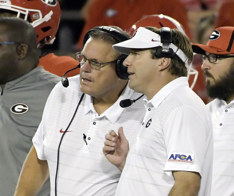 Georgia offensive line coach Sam Pittman, left, and Bulldogs head coach Kirby Smart worked together for four seasons in Athens before Pittman was named Sunday as the new Arkansas head coach. / Georgia photo by John Kelley