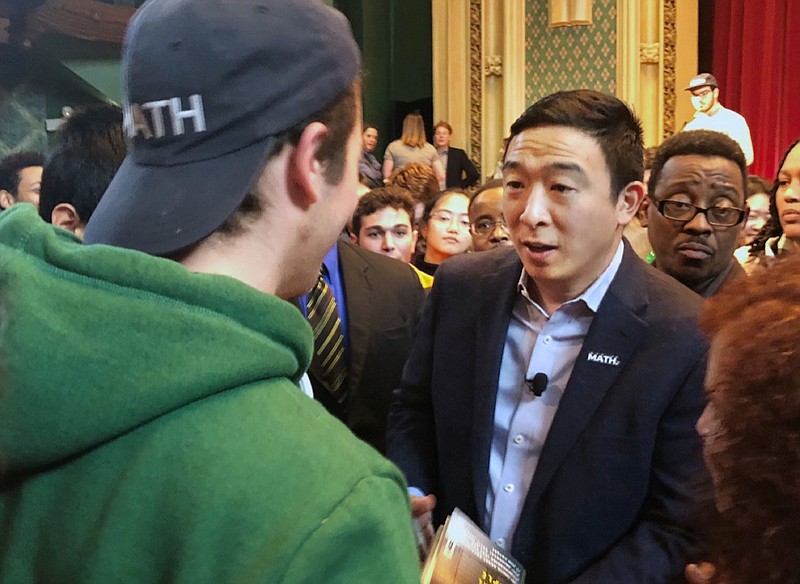 In this Dec. 5, 2019, photo Democratic presidential candidate Andrew Yang greets supporters at a campaign event at the University of Chicago in Chicago. Of all the Democrats in the wide field running for president, Andrew Yang is having the most fun. Unburdened by expectations and untethered to political convention, the tech entrepreneur has spent months cruising around the country, delivering dark warnings about America's new tech economy with an odd mix of millennial humor and bite. (AP Photo/ Sara Burnett)