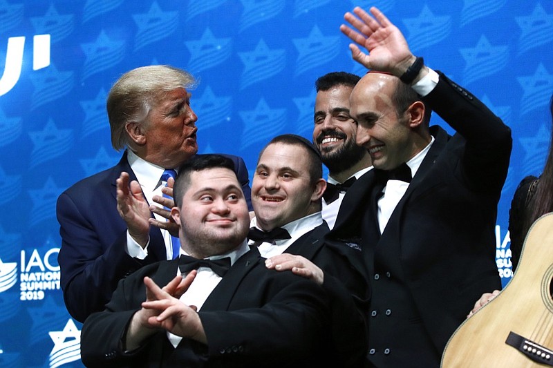 President Donald Trump visits with members of The Shalva Band after speaking at the Israeli American Council National Summit in Hollywood, Fla., Saturday, Dec. 7, 2019. (AP Photo/Patrick Semansky)