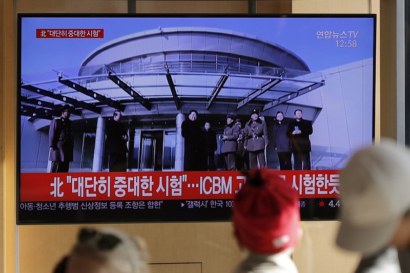 People watch a TV news program reporting North Korea's announcement with a file footage of North Korean leader Kim Jong Un, at the Seoul Railway Station in Seoul, South Korea, Sunday, Dec. 8, 2019. North Korea said Sunday it carried out a "very important test" at its long-range rocket launch site that U.S. and South Korean officials said the North had partially dismantled as part of denuclearization steps. The letters read "North. Very important test." (AP Photo/Lee Jin-man)