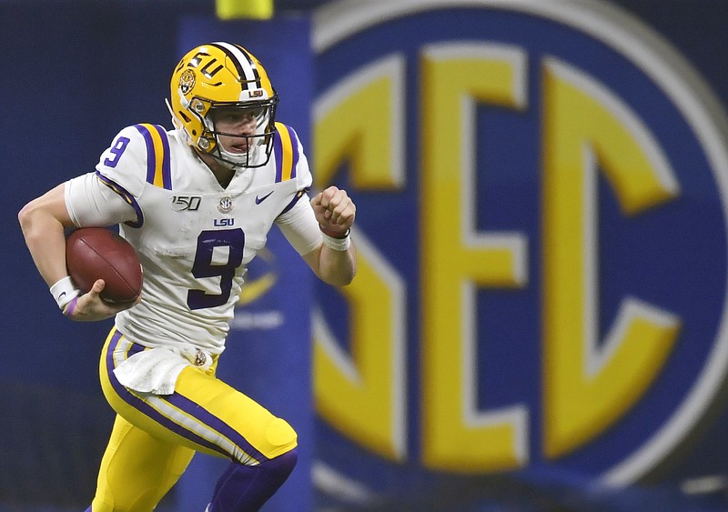 In this Dec. 7, 2019, file photo, LSU quarterback Joe Burrow (9) runs against Georgia during the second half of the Southeastern Conference championship NCAA college football game, in Atlanta. Burrow is a unanimous selection as the offensive player of the year on The Associated Press All-Southeastern Conference football team, Monday, Dec. 9, 2019. (AP Photo/Mike Stewart, File)