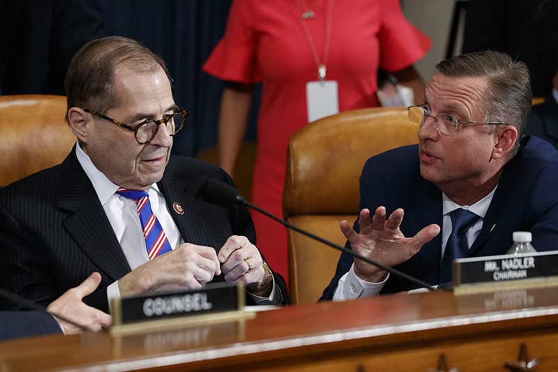 House Judiciary Committee Chairman Rep. Jerrold Nadler, D-N.Y., left, listens to ranking member Rep. Doug Collins, R-Ga., after the House Judiciary Committee hearing on the constitutional grounds for the impeachment of President Donald Trump, on Capitol Hill in Washington, Wednesday, Dec. 4, 2019 (AP Photo/Alex Brandon)