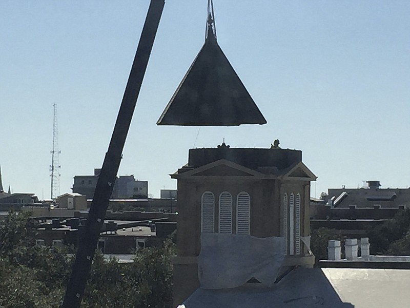 A construction crane lifts the renovated steeple back atop Savannah, Georgia's First African Baptist Church on Wednesday. The 160-year-old church, a national historic landmark believed to be the oldest black church in America, has been restored at a cost of nearly $600,000, according to the Savannah Morning News. / Staff photo/Alex Chambliss
