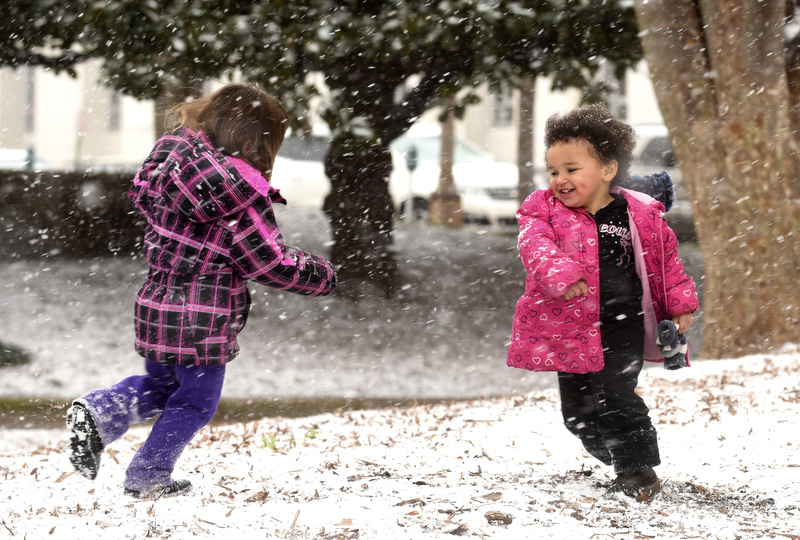 Cadence, left, and Mary Bartel play in the snow at Miller Park Tuesday, February 9, 2016.
