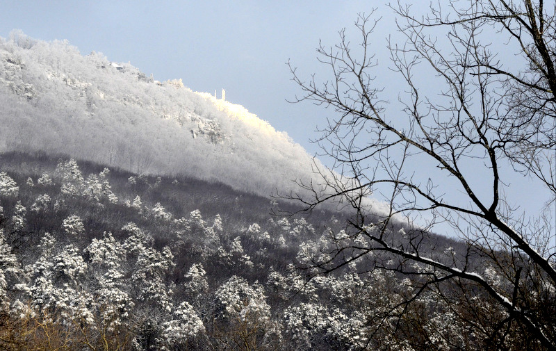 The rising sun lights the top of a snow-covered Lookout Mountain on Thursday morning following substantial overnight snowfall in Chattanooga.