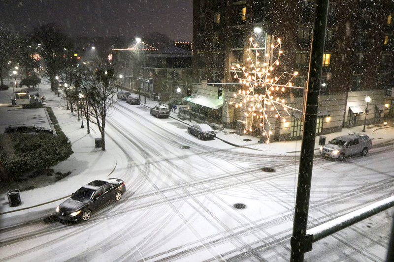 Staff Photo by Dan Henry / The Chattanooga Times Free Press- 2/20/15. Vehicles drive carefully at the intersection of W. Aquarium Way and Chestnut Street as snow falls in downtown Chattanooga, on Friday, February 20, 2015.