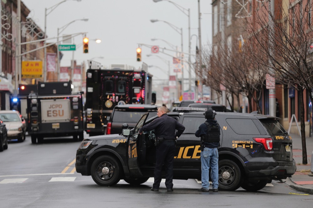 Jersey City Police officers man a road block following reports of gunfire, Tuesday, Dec. 10, 2019, in Jersey City, N.J. (AP Photo/Seth Wenig)