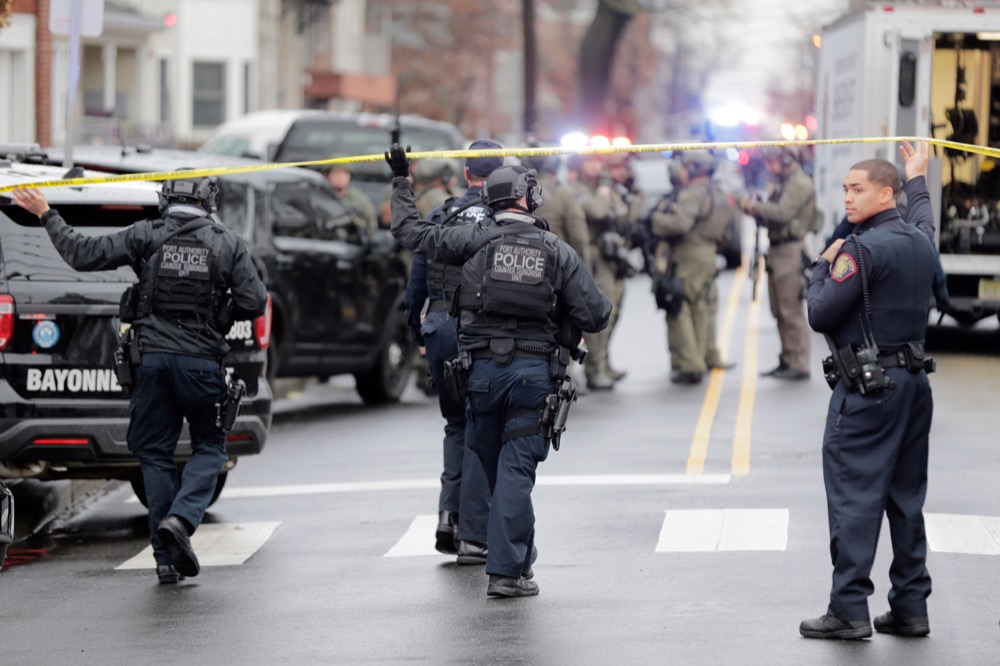 Port Authority Police officers arrive at the scene following reports of gunfire, Tuesday, Dec. 10, 2019, in Jersey City, N.J. (AP Photo/Seth Wenig)