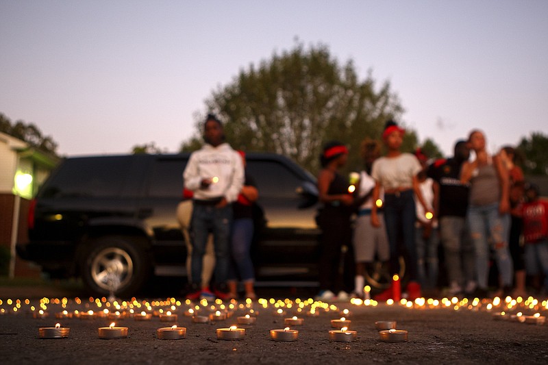 Staff photo by C.B. Schmelter/ Candles burn during a vigil for Quintasia Tate at the Rainbow Creek apartment complex on Wednesday, Aug. 28, 2019 in Chattanooga, Tenn. Tate, 19, was killed on Aug. 26th.