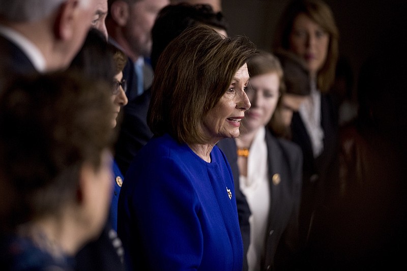 House Speaker Nancy Pelosi of Calif., accompanied by House Congress members, speaks at a news conference to discuss the United States Mexico Canada Agreement (USMCA) trade agreement, Tuesday, Dec. 10, 2019, on Capitol Hill in Washington. (AP Photo/Andrew Harnik)