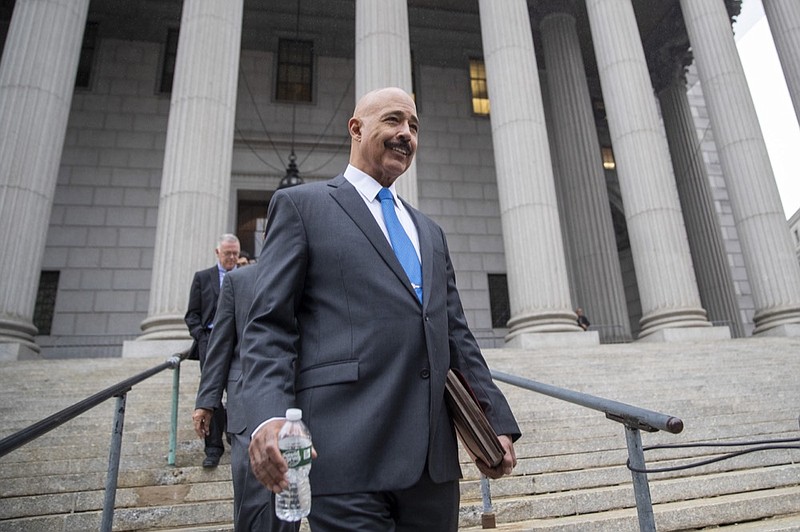 FILE - In this Oct. 22, 2019, file photo, Ted Wells, Jr., the lead attorney for Exxon, leaves New York Supreme Court in New York, after opening arguments in a lawsuit against Exxon. Exxon Mobil prevailed Tuesday, Dec. 10, 2019, in a lawsuit accusing the energy giant of downplaying the toll that climate change regulations could take on its business, with a judge saying the state attorney general's case didn't prove the company deceived investors — but also didn't excuse it of any accountability for global warming (AP Photo/Mary Altaffer, File)

