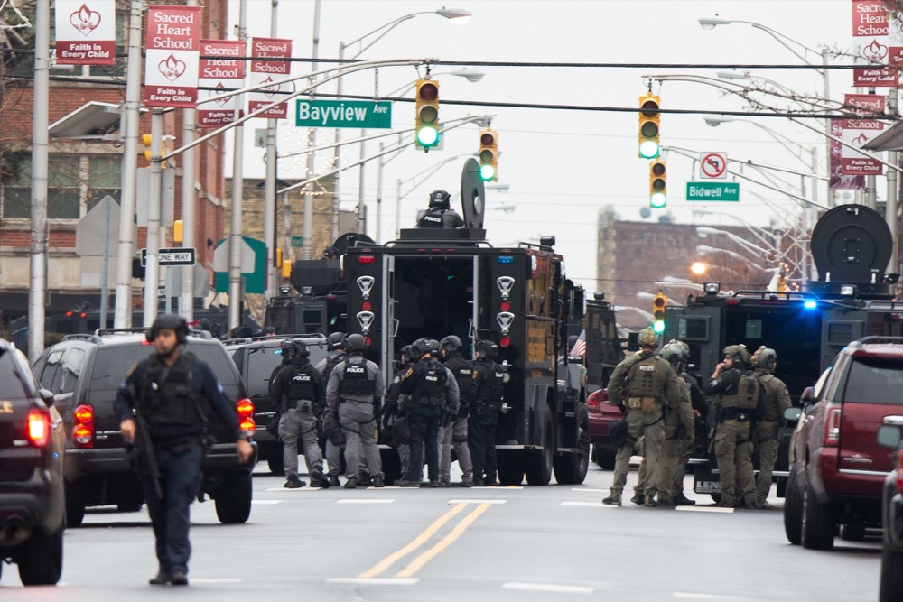 Law enforcement gathers near the scene following reports of gunfire, Tuesday, Dec. 10, 2019, in Jersey City, N.J. AP Photo/Eduardo Munoz Alvarez)