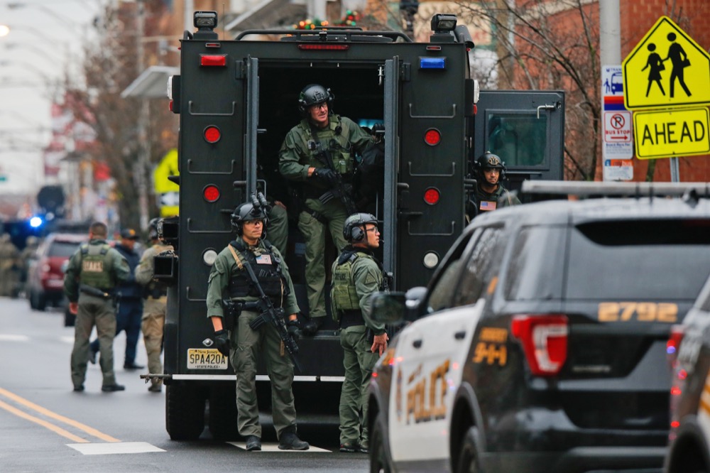 Law enforcement gathers near the scene following a shooting, Tuesday, Dec. 10, 2019, in Jersey City, N.J. AP Photo/Eduardo Munoz Alvarez)