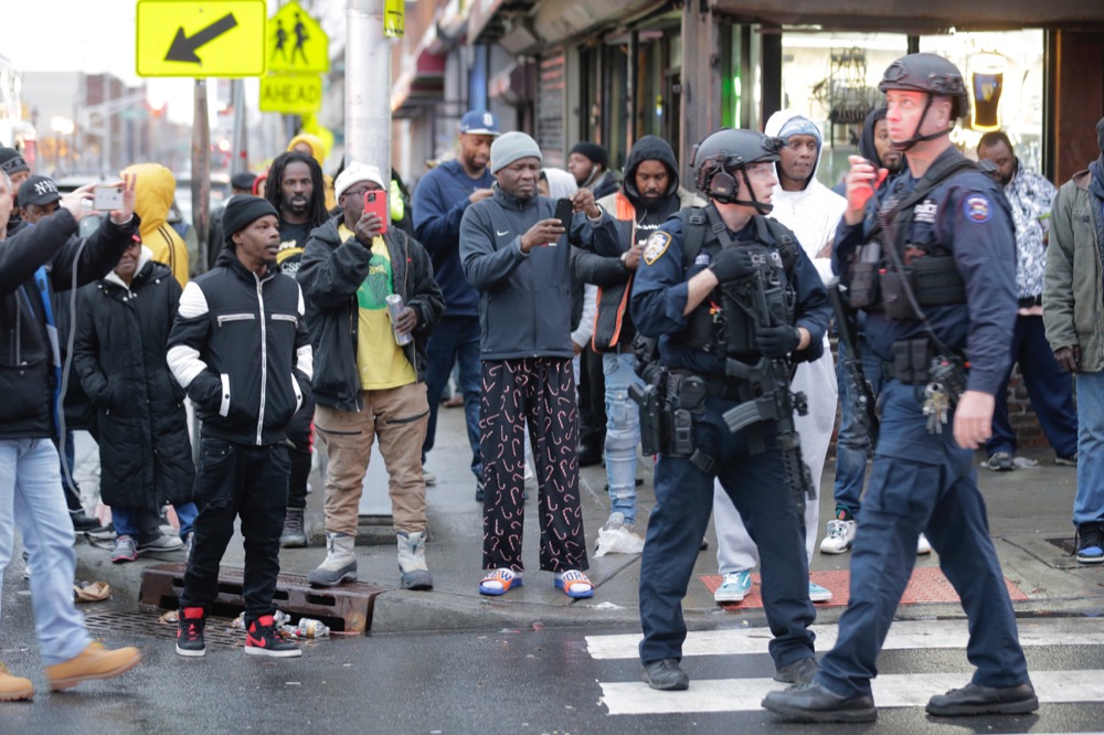Bystanders look on as law enforcement arrive on the scene following reports of shooting, Tuesday, Dec. 10, 2019, in Jersey City, N.J. (AP Photo/Seth Wenig)