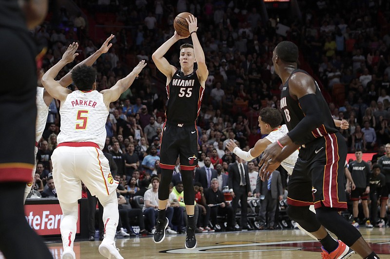 Miami Heat forward Duncan Robinson (55) shoots a 3-pointer as Atlanta Hawks forward Jabari Parker (5) defends during overtime of an NBA basketball game, Tuesday, Dec. 10, 2019, in Miami. The Heat won 135-121 in overtime. (AP Photo/Lynne Sladky)