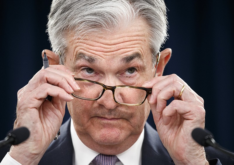 Federal Reserve Chair Jerome Powell removes his glasses as he listens to a question during a news conference after the Federal Open Market Committee meeting, Wednesday, Dec. 11, 2019, in Washington. The Federal Reserve is leaving its benchmark interest rate alone and signaling that it expects to keep low rates unchanged through next year. (AP Photo/Jacquelyn Martin)