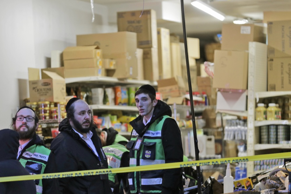 Emergency responders work at a kosher supermarket, the site of shooting in Jersey City, N.J., Wednesday, Dec. 11, 2019. The mayor of a New Jersey city says gunmen targeted the kosher market during a shooting that killed six people Tuesday. (AP Photo/Seth Wenig)