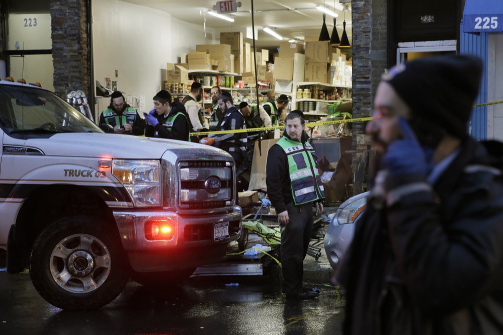 Emergency responders work at a kosher supermarket, the site of shooting in Jersey City, N.J., Wednesday, Dec. 11, 2019. The mayor of a New Jersey city says gunmen targeted the kosher market during a shooting that killed six people Tuesday. (AP Photo/Seth Wenig)