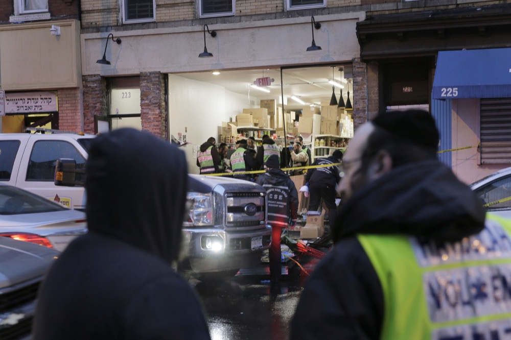 Emergency responders work at a kosher supermarket, the site of shooting in Jersey City, N.J., Wednesday, Dec. 11, 2019. The mayor of a New Jersey city says gunmen targeted the kosher market during a shooting that killed six people Tuesday. (AP Photo/Seth Wenig)