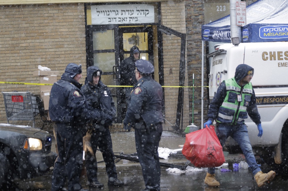 Emergency responders work near a kosher supermarket and a synagogue near the site of shooting in Jersey City, N.J., Wednesday, Dec. 11, 2019. The mayor of a New Jersey city says gunmen targeted the kosher market during a shooting that killed six people Tuesday. (AP Photo/Seth Wenig)