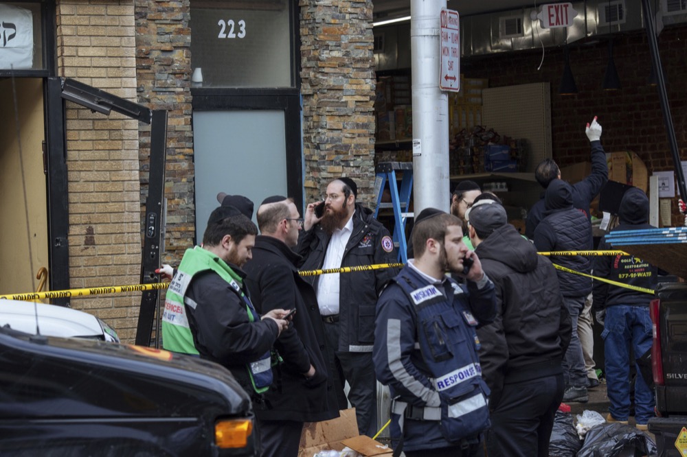 Responders work to clean up the scene of a shooting that left multiple dead at a kosher market on Dec. 11, 2018, in Jersey City, NJ. Police killed two gunmen who had earlier killed an officer at a cemetery in Jersey City. (AP Photo/Kevin Hagen).
