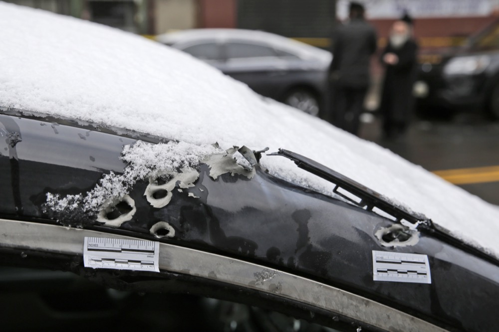 Bullets holes and stickers placed by investigators are seen near the scene of a shooting at a kosher supermarket in Jersey City, N.J., Wednesday, Dec. 11, 2019. The mayor of a New Jersey city says gunmen targeted the kosher market during a shooting that killed multiple people Tuesday. (AP Photo/Seth Wenig)