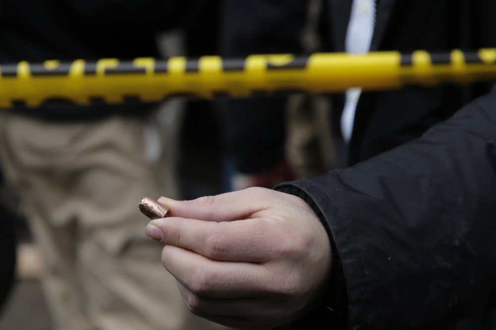 A man displays a bullet shell recovered from a shooting at a kosher supermarket in Jersey City, N.J., Wednesday, Dec. 11, 2019. The mayor of a New Jersey city says gunmen targeted the kosher market during a shooting that killed multiple people Tuesday. (AP Photo/Seth Wenig)
