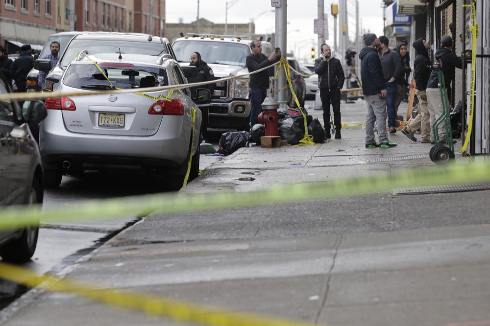 People work to secure the scene of a shooting at a kosher supermarket in Jersey City, N.J., Wednesday, Dec. 11, 2019. The mayor of a New Jersey city says gunmen targeted the kosher market during a shooting that killed six people Tuesday. (AP Photo/Seth Wenig)