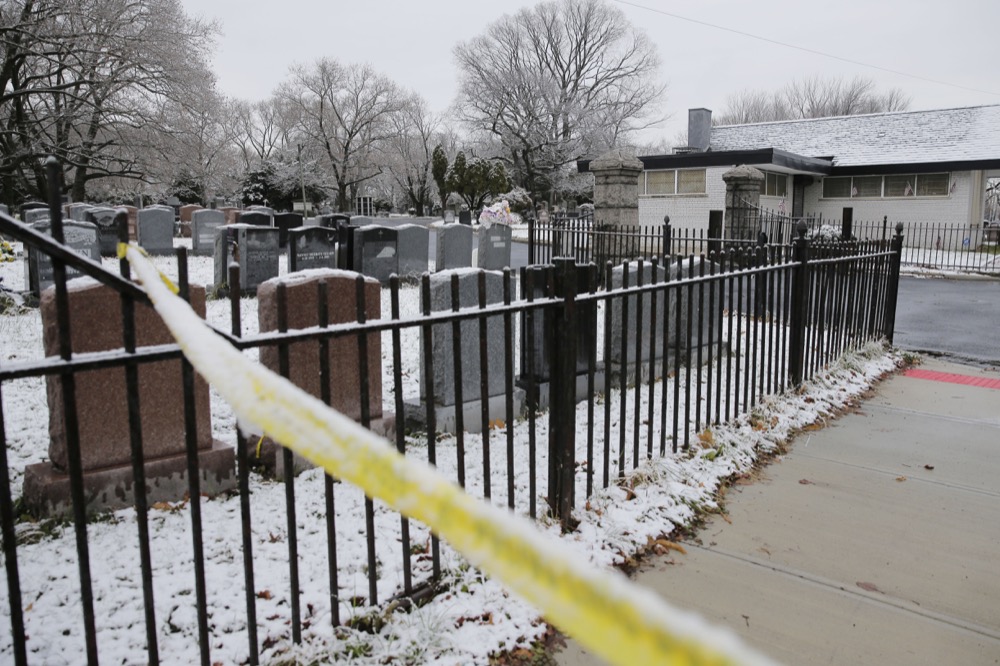 A piece of police tape is seen by Bay View Cemetery in Jersey City, N.J., Wednesday, Dec. 11, 2019. The two gunmen in a furious firefight that left six people dead in Jersey City clearly targeted a Jewish market, the mayor said Wednesday, amid growing suspicions the bloodshed was an anti-Semitic attack. The shooting began near the cemetery, where Det. Joseph Seals, a 40-year-old member of a unit devoted to taking illegal guns off the street, was killed while trying to stop "bad guys," Police Chief Michael Kelly said without elaborating. (AP Photo/Seth Wenig)