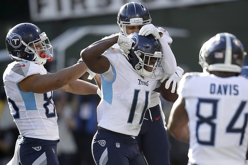 Tennessee Titans wide receiver A.J. Brown (11) is congratulated by teammates after scoring against the Oakland Raiders on Sunday. / AP Photo by Ben Margot