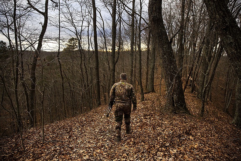 Dale Ferguson heads into the woods with his bow to hunt for deer in December 2017 in Isonville, Ky. Divisions among types of hunters and even within those groups are taking a toll, writes outdoors columnist Larry Case. / AP photo by David Goldman