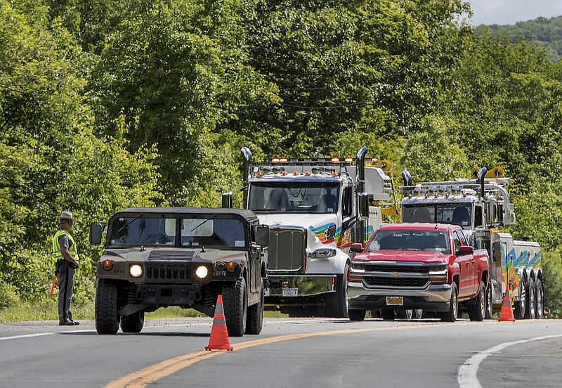 FILE - In this June 6, 2019, file photo, military police direct traffic along Route 293 near the site where an armored personnel vehicle overturned and killed a West Point cadet killing in Cornwall, N.Y.  Staff Sgt. Ladonies Strong, an Army soldier based in Georgia, will face a trial by court-martial after being charged in the vehicle rollover, a Fort Stewart spokesman said Wednesday, Dec. 11.  (AP Photo/Allyse Pulliam, File)