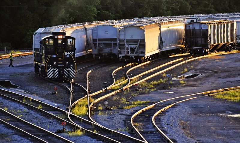 Staff Photo by Robin Rudd /
The setting sun glistens upon the rails as a Norfolk Southern train crew switches out covered hoppers behind the Pilgrims Pride plant near the Choo-Choo on April 27, 2017. Know as East End, numerous trains a day traverse the area as the mainlines of both the Norfolk Southern and CSX railroads are just yards east of these yard tracks.
