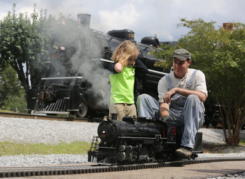 Staff photo by Erin O. Smith /
Duncan Kroulek, 5, asks Jessi Krebs about his replica 4501 train during Railfest Sunday, September 9, 2018 at the Tennessee Valley Railroad Museum in Chattanooga, Tennessee. The train is a replica of the larger train sitting in the background.