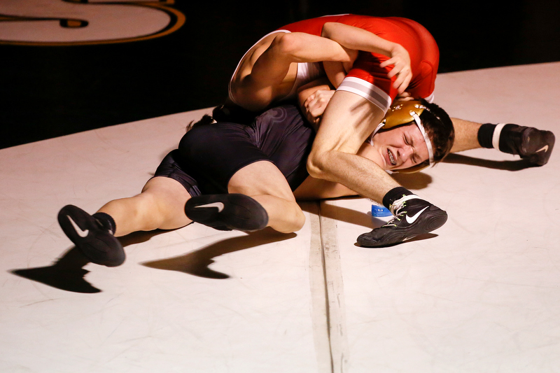 Baylor's Kade Hartline, top, wrestles with Bradley Central's Easton Lipsey during the 113-pound match Thursday night at Jim Smiddy Arena in Cleveland, Tenn. Hartline earned a 5-2 decision, and the Red Raiders won the match 49-15. / Staff photo by C.B. Schmelter