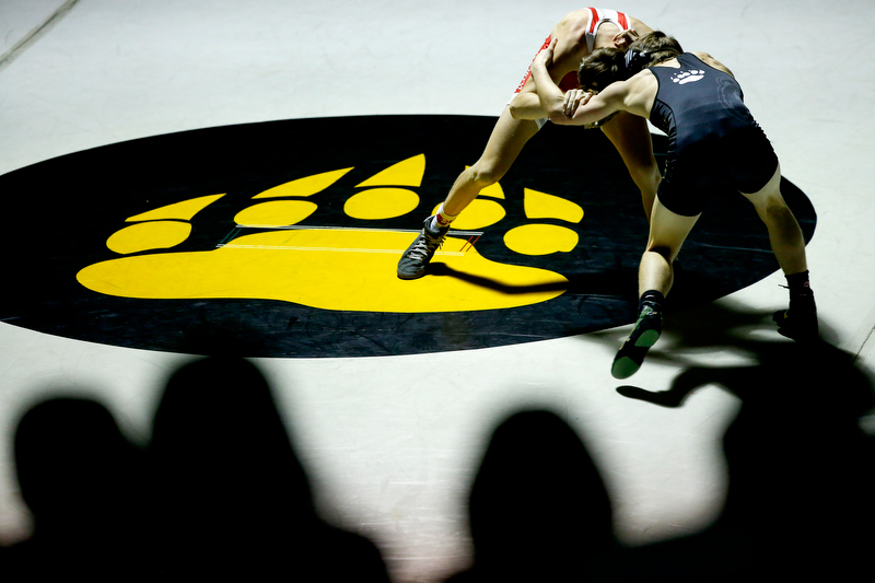 Staff photo by C.B. Schmelter / The crowd looks on as Baylor's Jackson Bond, top, and Bradley Central's Luke Belcher wrestle during a 120-pound bout in Bradley Central High School's Jim Smiddy Arena on Thursday, Dec. 12, 2019 in Cleveland, Tenn. Belcher won the bout.